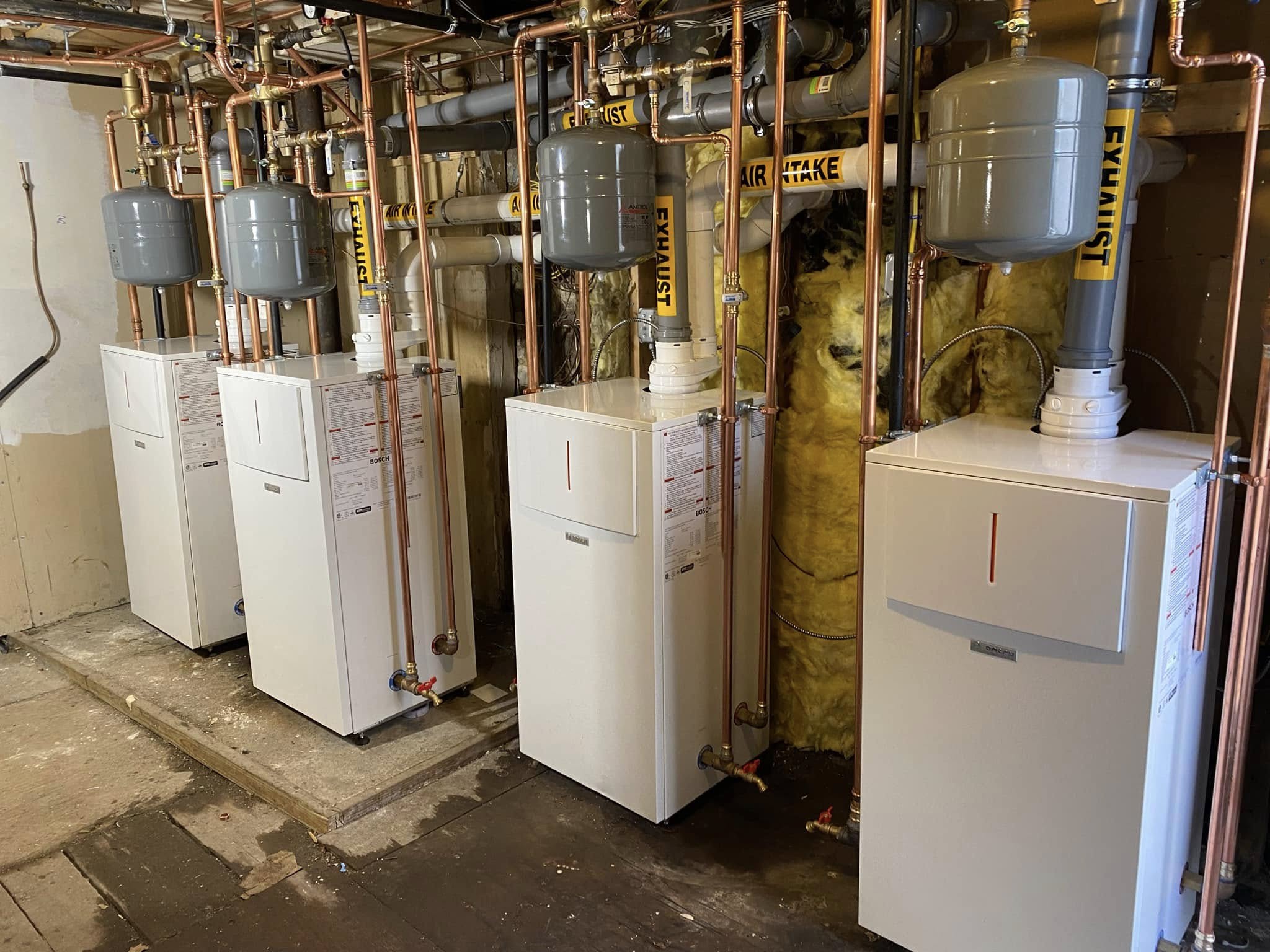 Bosch boilers and copper piping installed in a basement by Sam's HVAC