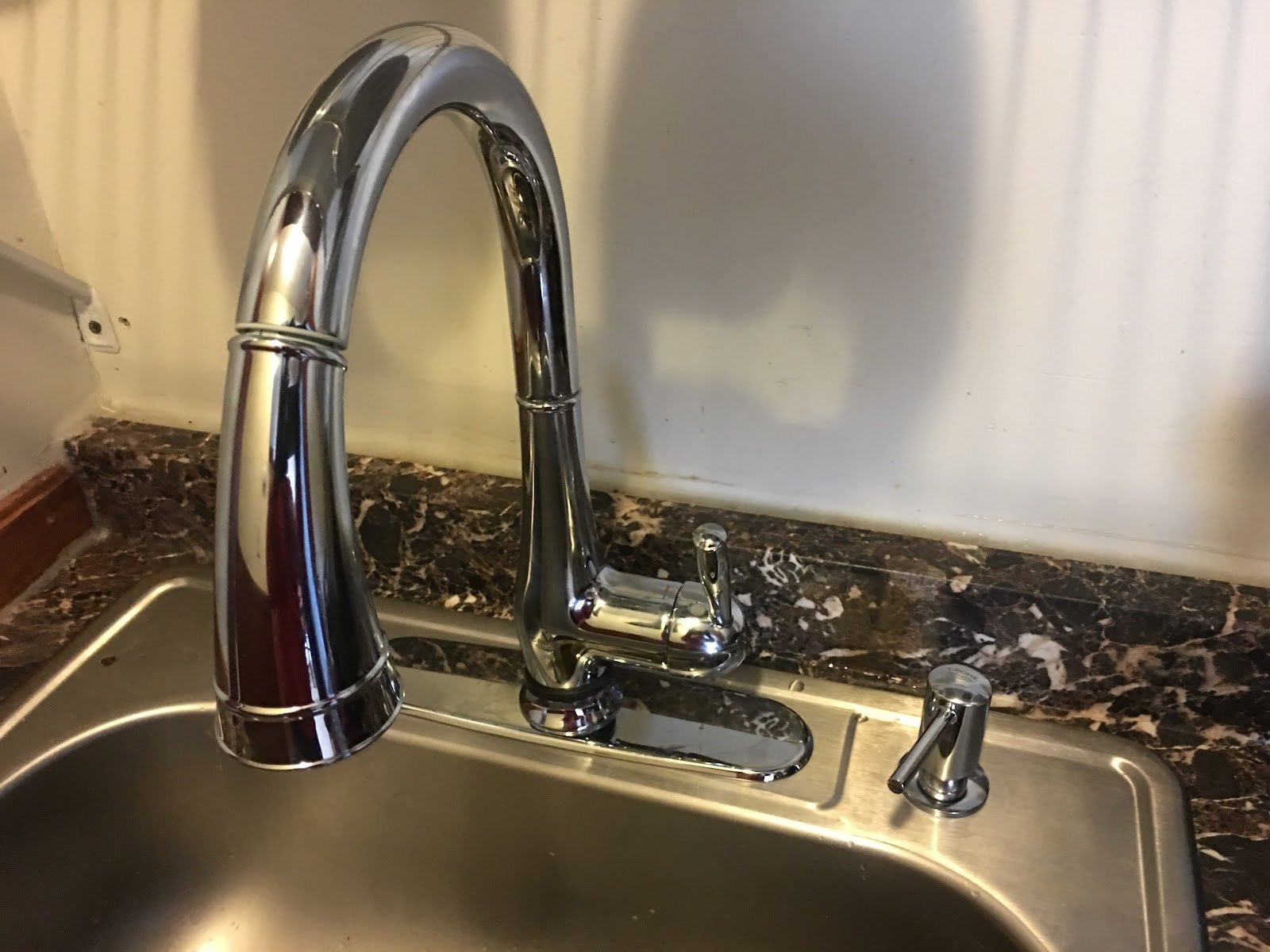 Chrome pull-down kitchen faucet installed by Sam's HVAC