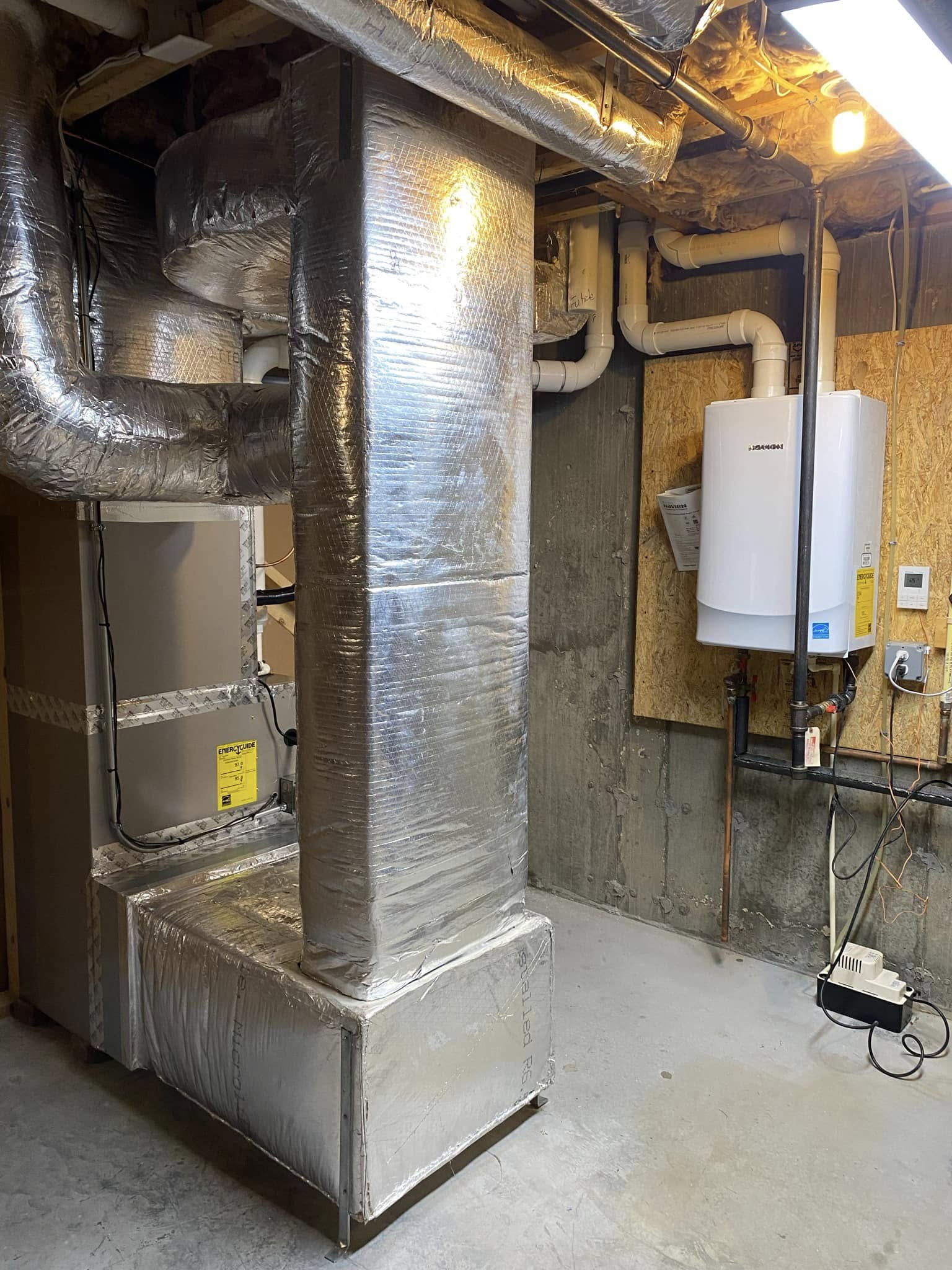 Ductwork and a wall mounted boiler installed by Sam's HVAC